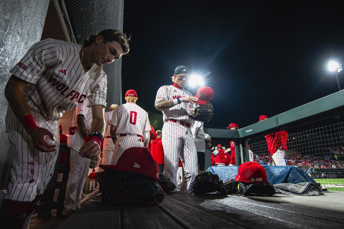 NC State players arrange their gear during the game against UNC in Doak Field at Dail Park on Thursday, May 14, 2026. The Tar Heels defeated the Wolfpack 9-4.