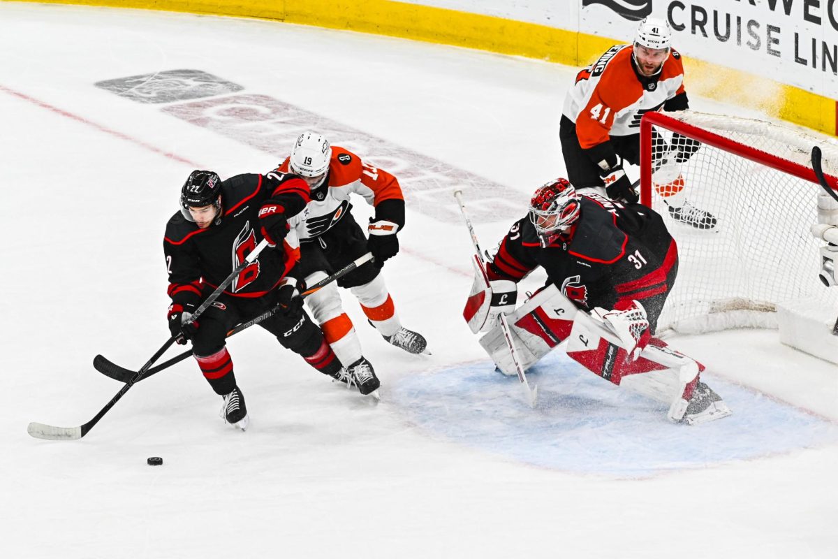 Center Logan Stankoven leads the puck away from goalie Frederik Andersen during Game One of Round Two in the Eastern Conference Playoffs against the Philadelphia Flyers at the Lenovo Center on Saturday, May. 2, 2026.  The Hurricanes defeated the Flyers 3-0.
