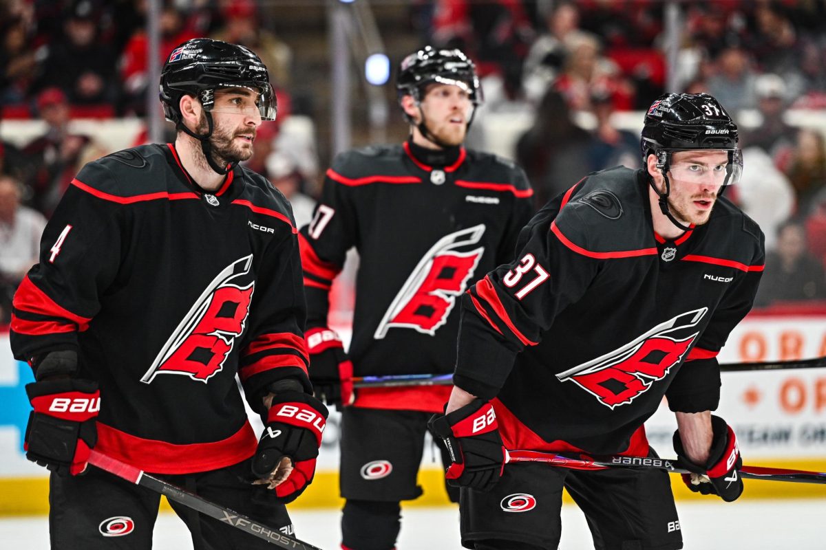 Defenseman Shayne Gostisbehere, left wing Nikolaj Ehlers, and right wing Andrei Svechnikov prepare for a face-off during Game One of Round Two in the Eastern Conference Playoffs against the Philadelphia Flyers at the Lenovo Center on Saturday, May. 2, 2026.  The Hurricanes defeated the Flyers 3-0.