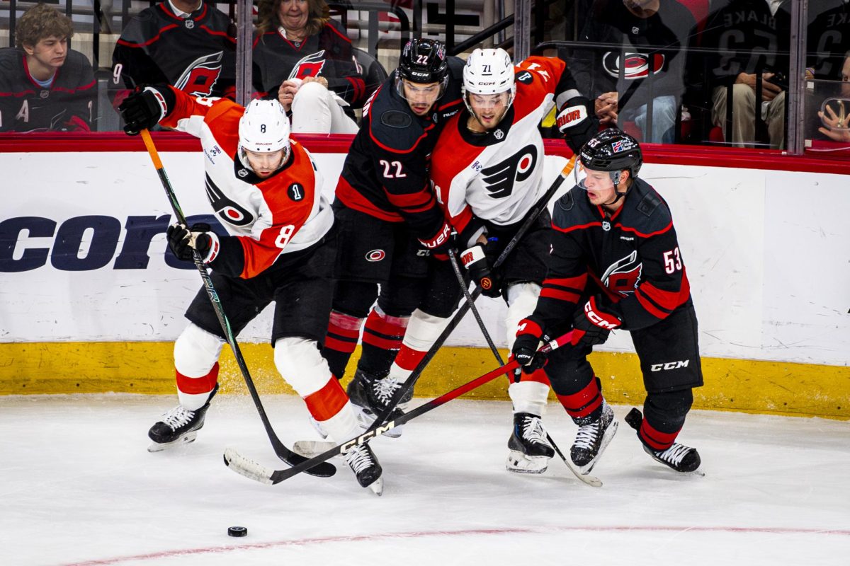 Players fight for possession fo the puck during Game Two of the Eastern Conference Semifinals between the Carolina Hurricanes and Philadelphia Flyers in the Lenovo Center on Monday, May 4, 2026. The Hurricanes defeated the Flyers 3-2 in overtime.
