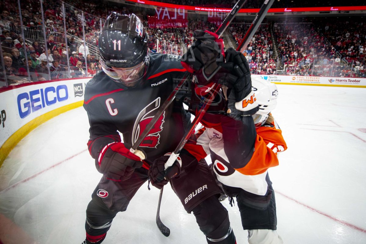 Hurricanes center Jordan Staal (11) and Flyers center Denver Barkey (52) battle for the puck near the boards during Game Two of the Eastern Conference Semifinals between the Carolina Hurricanes and Philadelphia Flyers in the Lenovo Center on Monday, May 4, 2026. The Hurricanes defeated the Flyers 3-2 in overtime.