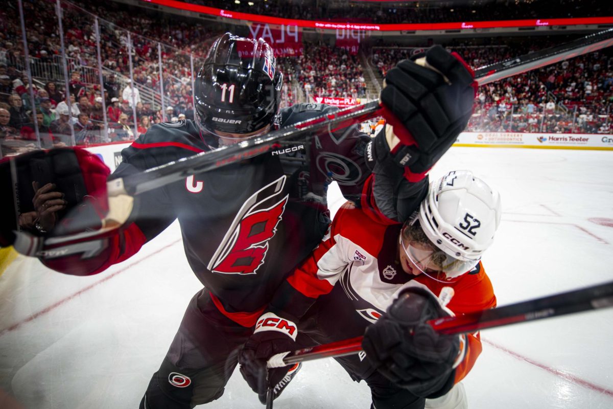 Hurricanes center Jordan Staal (11) and Flyers center Denver Barkey (52) battle for the puck near the boards during Game Two of the Eastern Conference Semifinals between the Carolina Hurricanes and Philadelphia Flyers in the Lenovo Center on Monday, May 4, 2026. The Hurricanes defeated the Flyers 3-2 in overtime.
