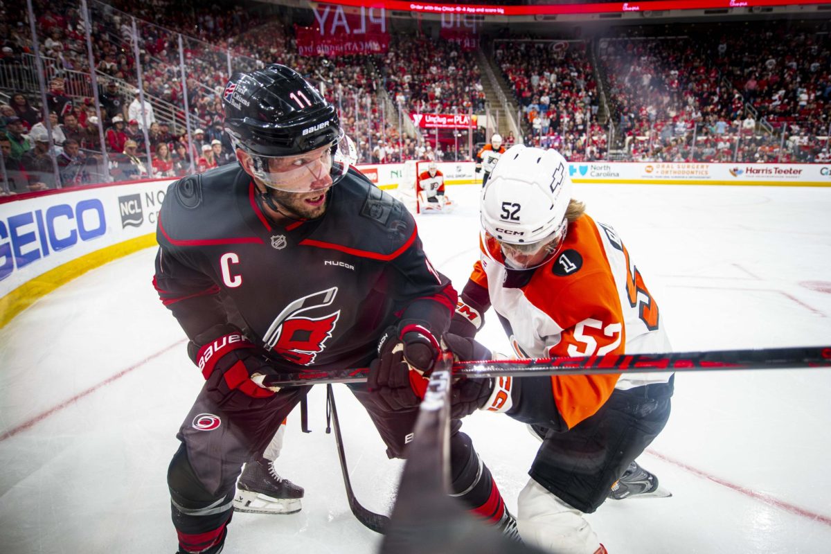 Hurricanes center Jordan Staal (11) and Flyers center Denver Barkey (52) battle for the puck near the boards during Game Two of the Eastern Conference Semifinals between the Carolina Hurricanes and Philadelphia Flyers in the Lenovo Center on Monday, May 4, 2026. The Hurricanes defeated the Flyers 3-2 in overtime.