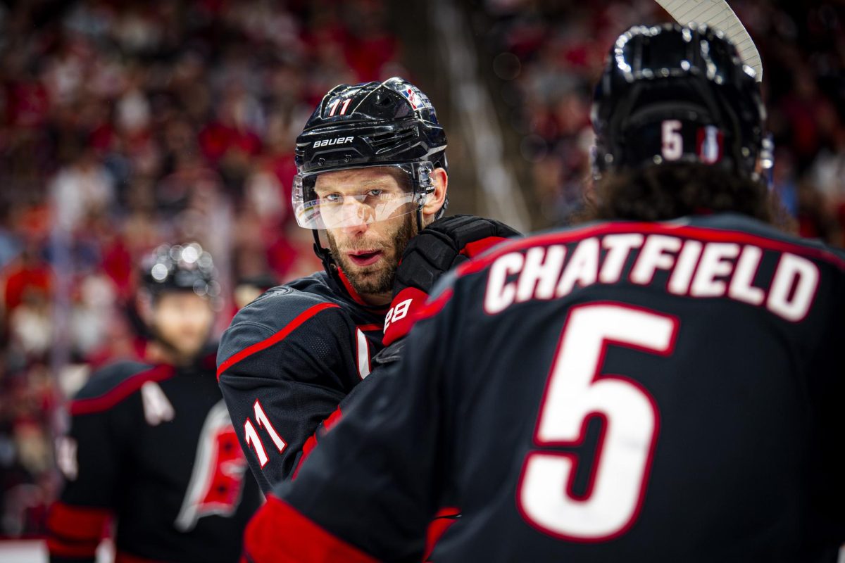 Center Jordan Staal speaks with defenseman Jalen Chatfield during Game Two of the Eastern Conference Semifinals between the Carolina Hurricanes and Philadelphia Flyers in the Lenovo Center on Monday, May 4, 2026. The Hurricanes defeated the Flyers 3-2 in overtime.