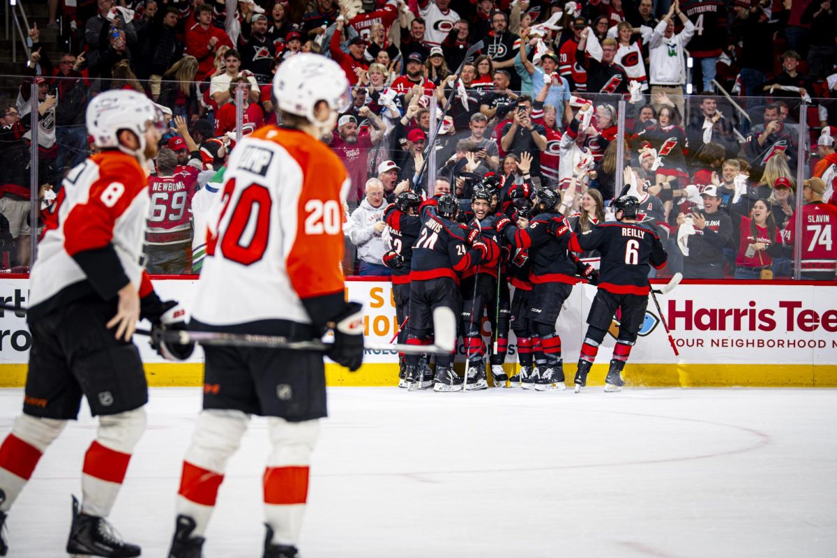 Hurricanes players celebrate as Flyers players skate off the ice after Taylor Hall's game-winning goal in overtime of Game Two of the Eastern Conference Semifinals against the Philadelphia Flyers in the Lenovo Center on Monday, May 4, 2026. The Hurricanes defeated the Flyers 3-2.