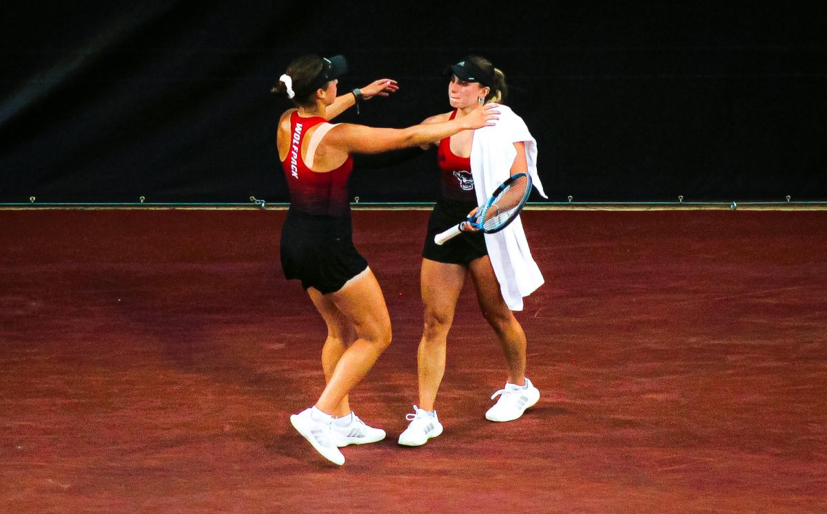 Junior Gabriella Broadfoot and senior Anna Zyryanova move to embrace each other after No. 8 NC State women's tennis lost 4-1 to No. 1 Georgia in the NCAA women's tennis championships semifinals, played at Dan Magill Tennis Complex in Athens, Georgia.