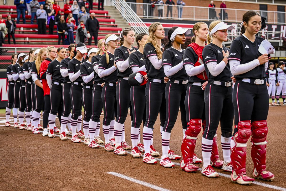 NC State players stand for the playing of the national anthem during the game against Louisville at Dail Softball Stadium on Saturday, May 2, 2026. NC State defeated Louisville 10-6.