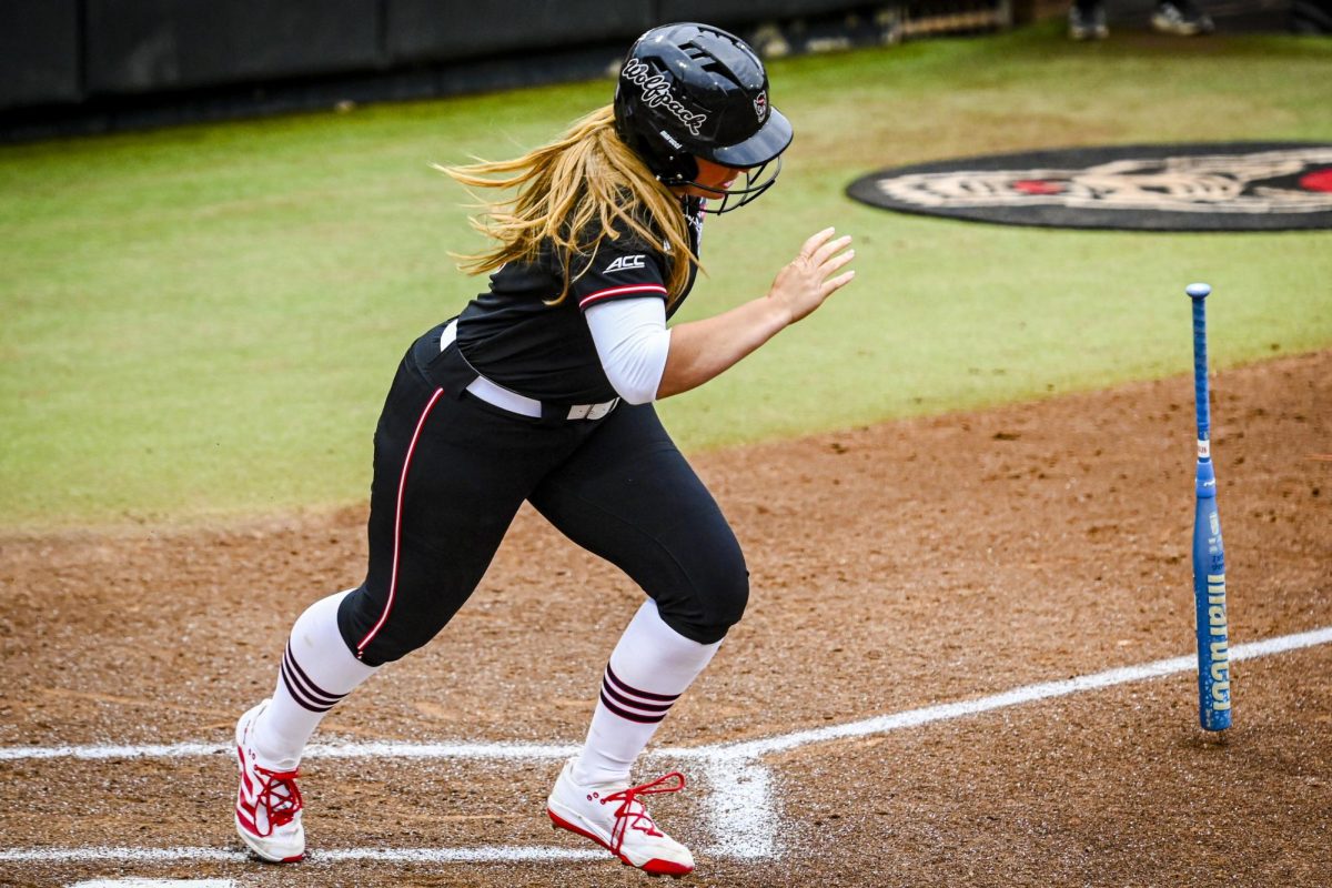 Senior utility Hannah Church flips her bat and sprints to first during the game against Louisville at Dail Softball Stadium on Saturday, May 2, 2026. NC State defeated Louisville 10-6.
