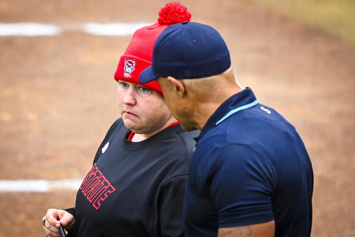 Head coach Lindsay Leftwich speaks with home plate umpire Young-Daniel Abanathey during the game against Louisville at Dail Softball Stadium on Saturday, May 2, 2026. NC State defeated Louisville 10-6.