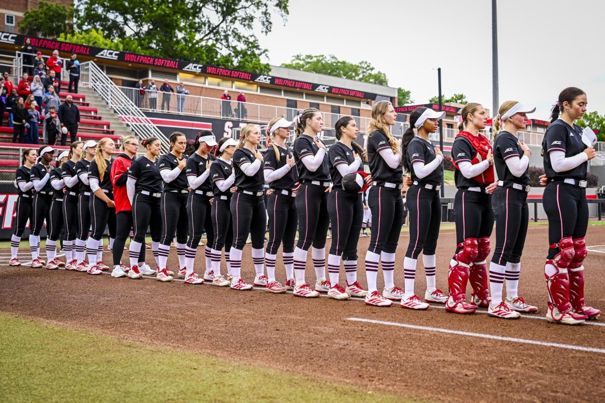 NC State players stand for the playing of the national anthem during the game against Louisville at Dail Softball Stadium on Saturday, May 2, 2026. NC State defeated Louisville 10-6.