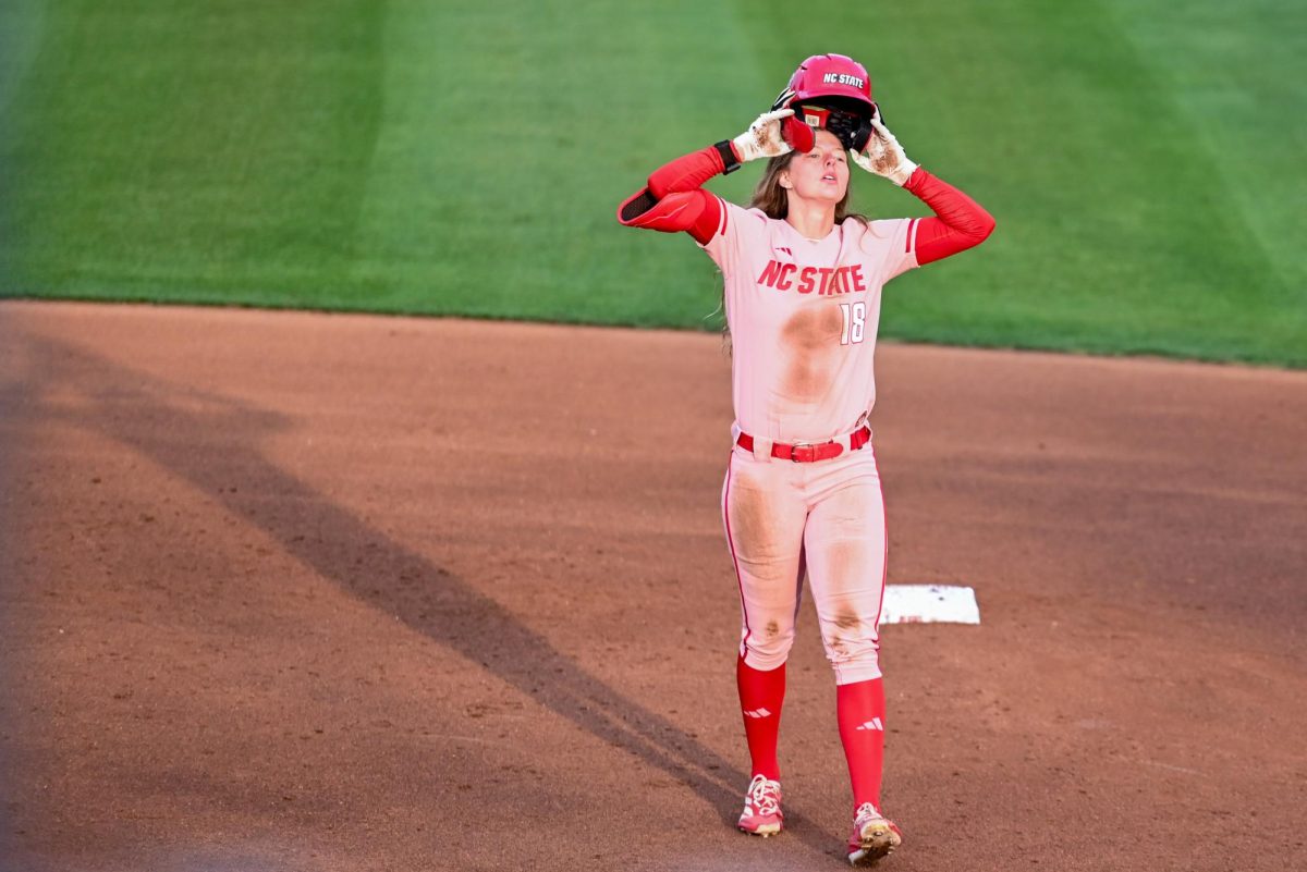Junior outfielder Sarah Johnson puts her helmet back on during the game against Louisville at Dail Softball Stadium on Friday, May 1, 2026. The Wolfpack fell to the Cardinals 5-1.