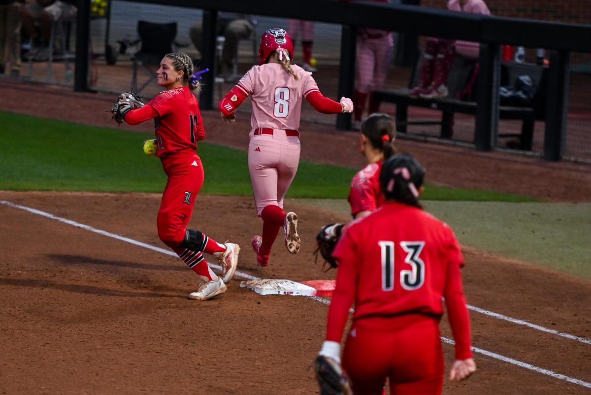 Freshman infielder Carly Short runs to first base during the game against Louisville at Dail Softball Stadium on Friday, May 1, 2026. The Wolfpack fell to the Cardinals 5-1.