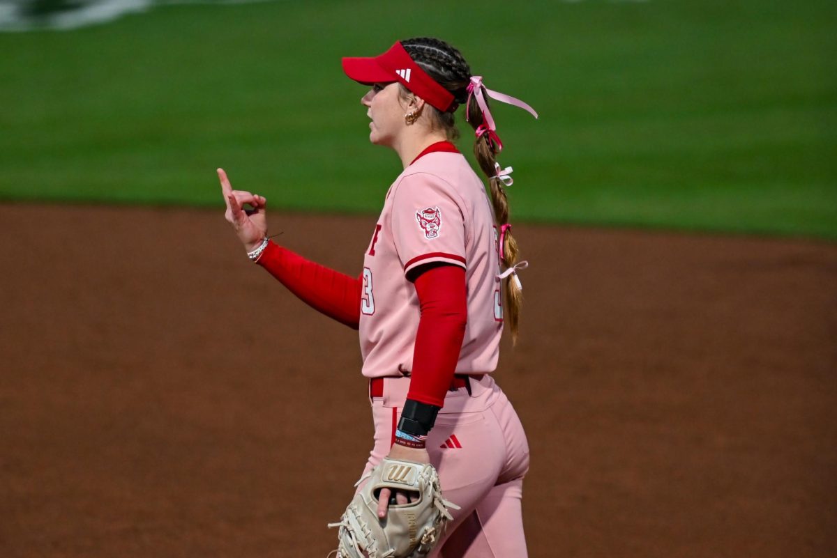 Freshman utilities player Morgan Talley throws up a sign during the game against Louisville at Dail Softball Stadium on Friday, May 1, 2026. The Wolfpack fell to the Cardinals 5-1.