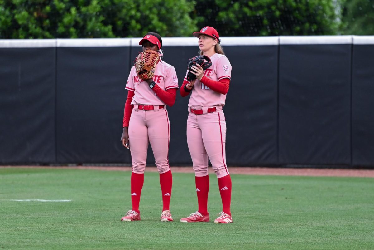Senior outfielder Maia Townsend and junior outfielder Sarah Johnson talk in the outfield during the game against Louisville at Dail Softball Stadium on Friday, May 1, 2026. The Wolfpack fell to the Cardinals 5-1.