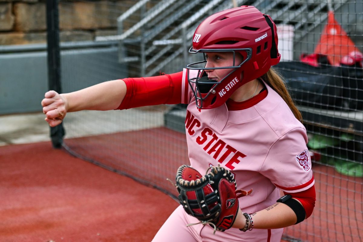 enior utilities player Hannah Church warms up in the dugout during the game against Louisville at Dail Softball Stadium on Friday, May 1, 2026. The Wolfpack fell to the Cardinals 5-1.