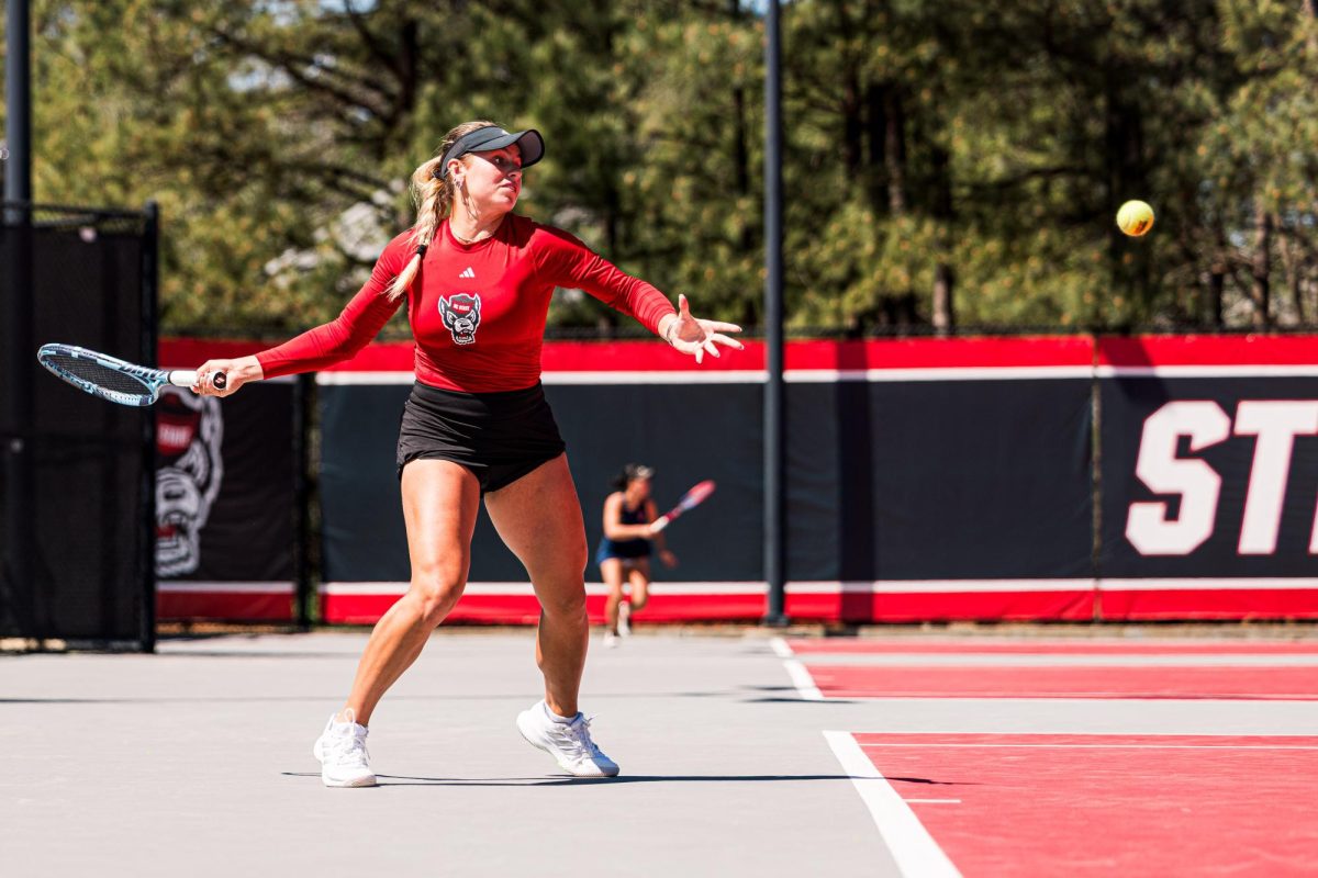 Junior Gabriella Broadfoot lunges back to hit the ball during the match against Syracuse at Dail Outdoor Tennis Stadium on Sunday, March 29, 2026. Broadfoot won her singles match (6-4, 6-1). NC State beat Syracuse 7-0.