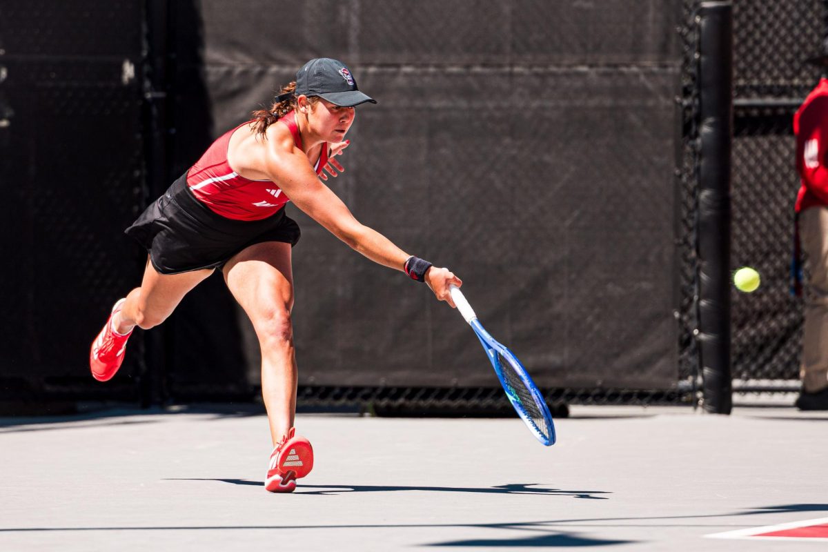 Sophomore Mia Slama rushes forward to hit the ball during the match against Syracuse at Dail Outdoor Tennis Stadium on Sunday, March 29, 2026. NC State beat Syracuse 7-0.