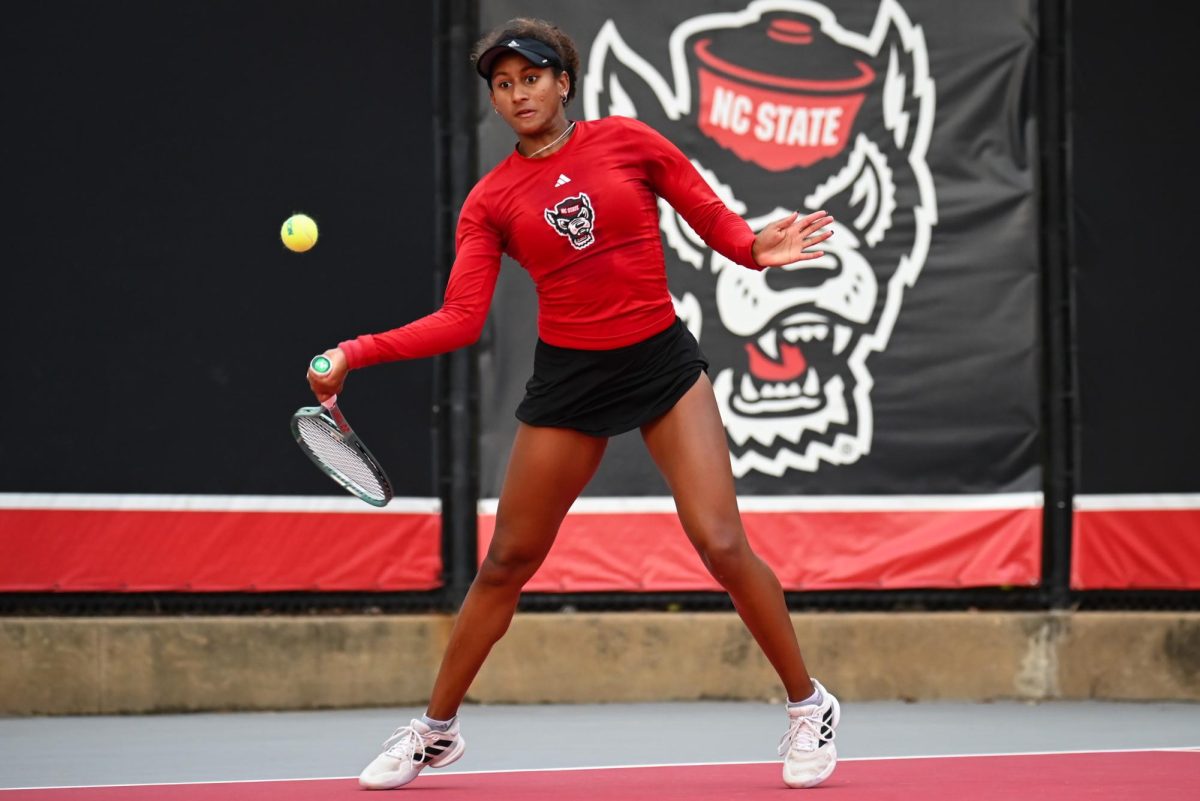 Freshman Victoria Osuigwe eyes the ball during the match against UCF in the second round of the NCAA Womens Tennis Championship at J.W. Isenhour Tennis Center on Saturday, May 2, 2026. Osuigwe defeated her singles opponent by a score of 6-1,6-0 in straight sets. The Wolfpack defeated the Knights 4-0.