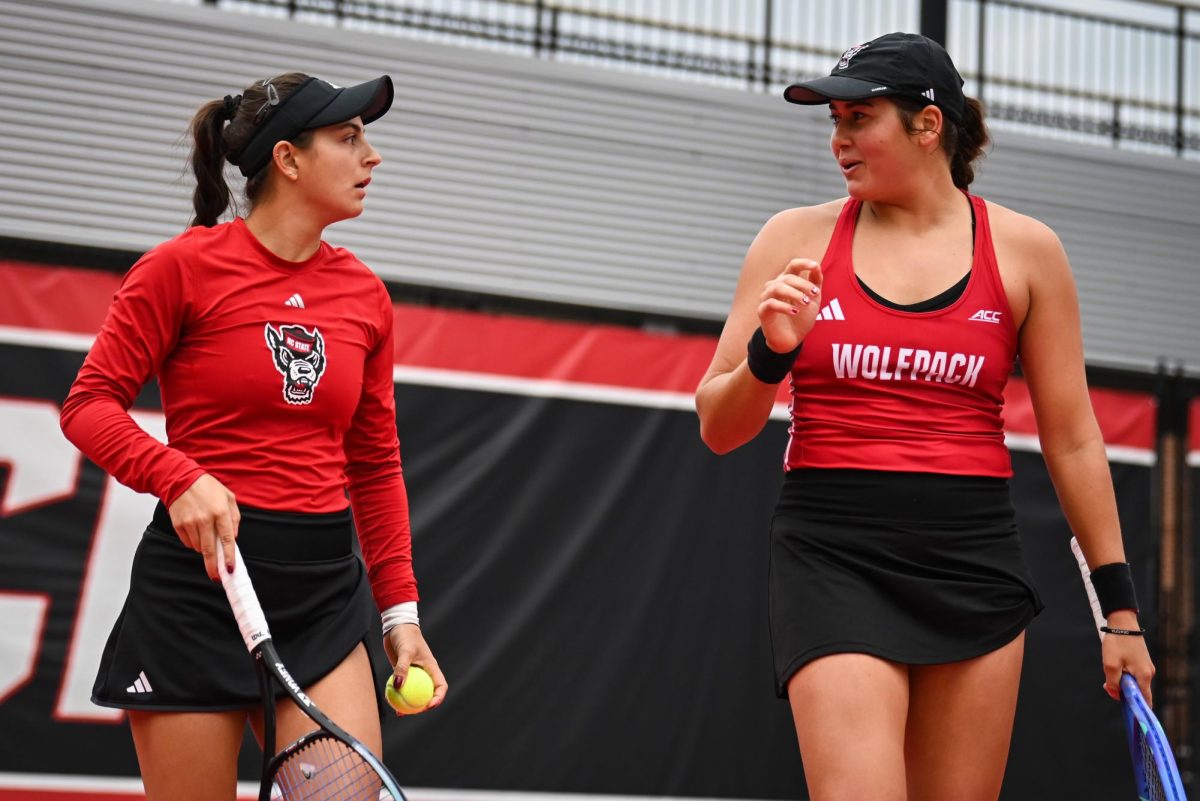 Freshman Lavinia Tanasie and Sophomore Mia Slama talk strategy in between points during the match against UCF in the second round of the NCAA Womens Tennis Championship at J.W. Isenhour Tennis Center on Saturday, May 2, 2026. The pair defeated their opponent in the doubles match by a score of 6-1. The Wolfpack defeated the Knights 4-0. 