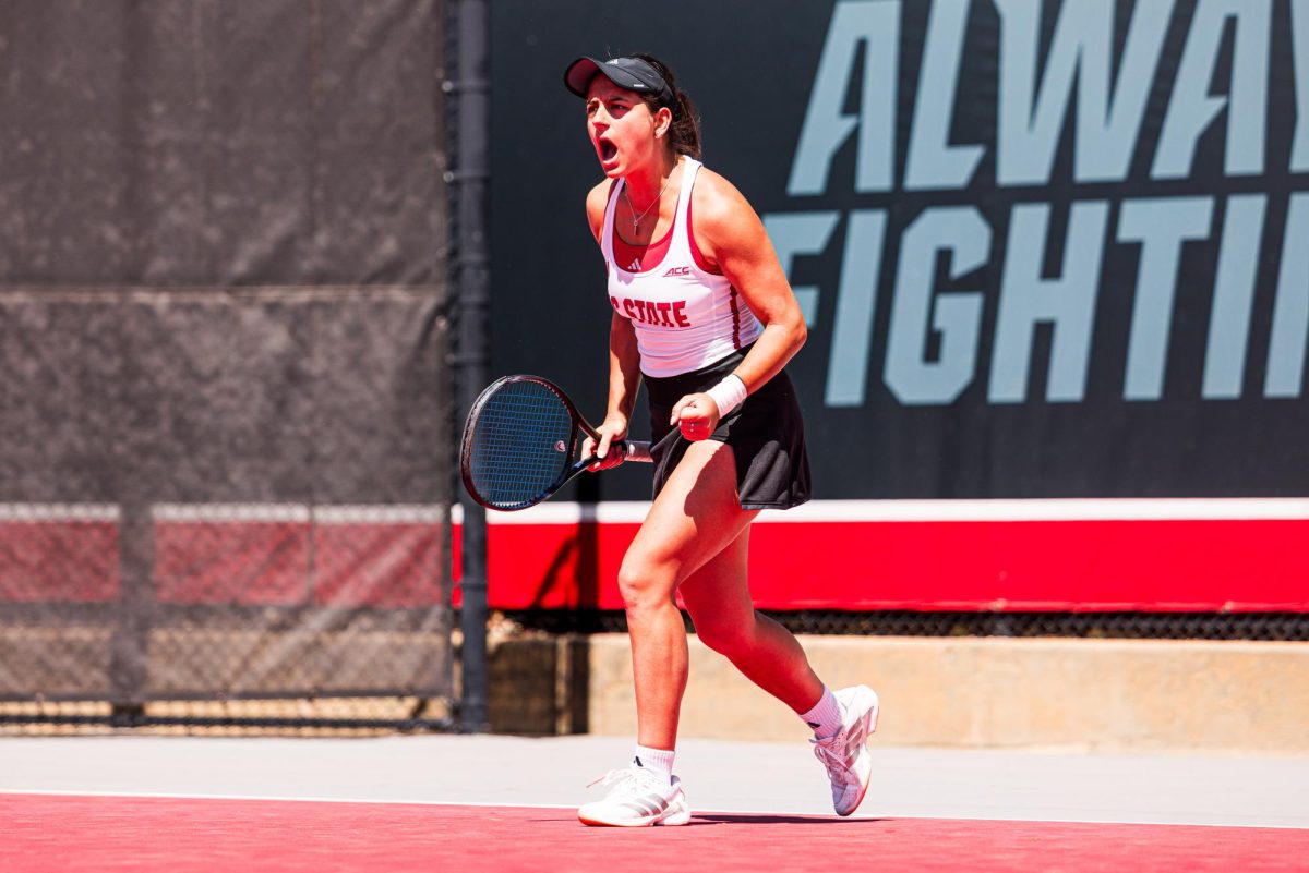 Freshman Lavinia Tanasie yells after winning her match against Syracuse at Dail Outdoor Tennis Stadium on Sunday, March 29, 2026. NC State beat Syracuse 7-0.