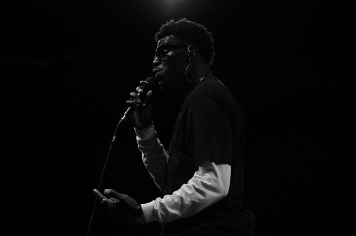 Lekan, a Nigerian-American R&B artist, sings into a microphone as an opening act for Ari Lennox at The Ritz Raleigh on Wednesday, June 3, 2026.