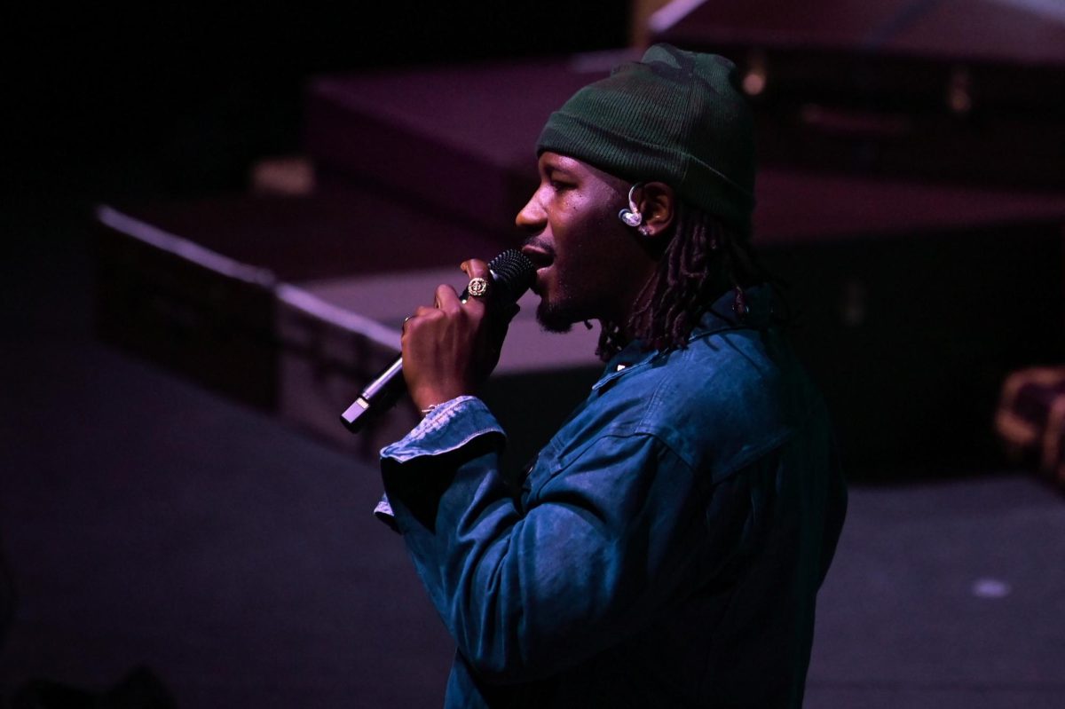 PHABO, an American R&B artist, sings into a microphone as an opening act for Ari Lennox at The Ritz Raleigh on Wednesday, June 3, 2026.