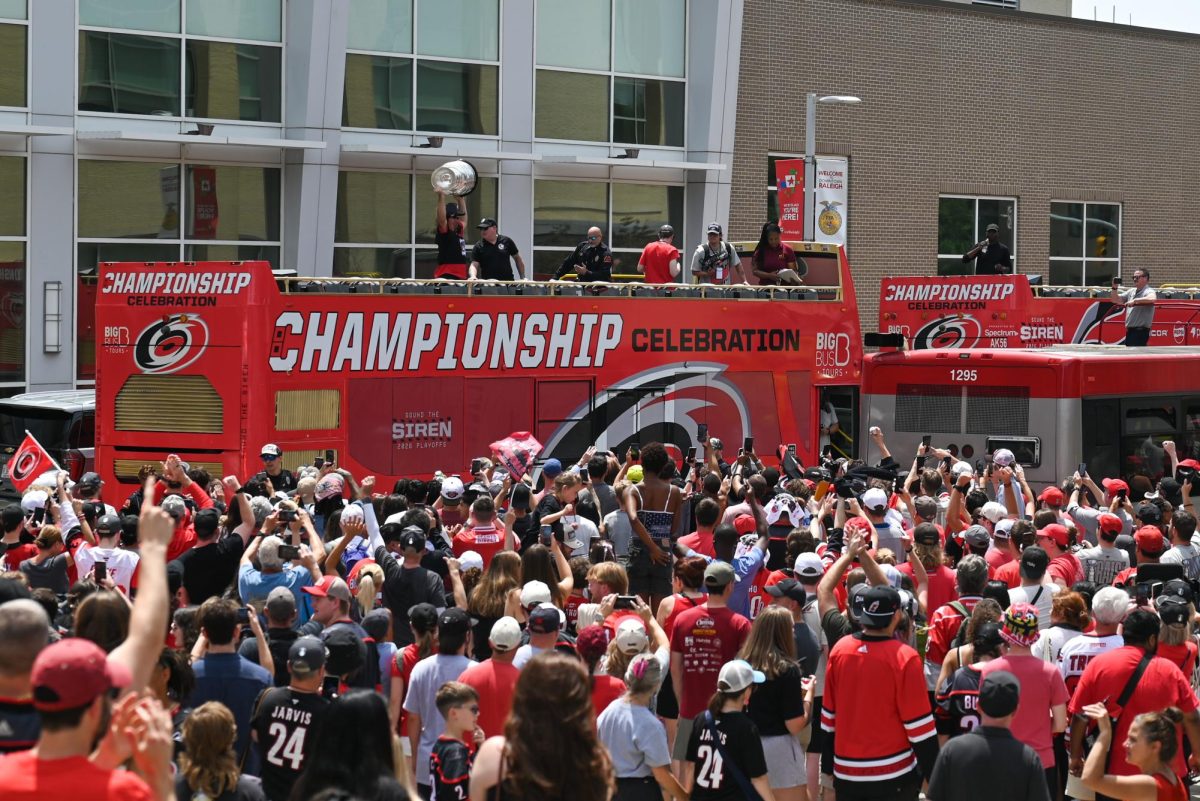 Hurricanes fans crowd around parade buses in Downtown Raleigh on June 20, 2026 during the Carolina Hurricanes Championship Parade. The parade had an attendance of 100000+ hockey fans from all parts of NC and the United States.