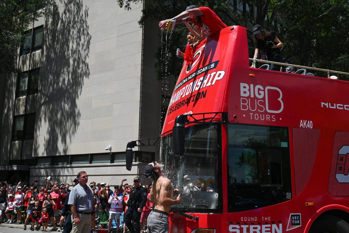 Forward William Carrier covered in alcohol in front of a parade bus in Downtown Raleigh on June 20, 2026 during the Carolina Hurricanes Championship Parade. The parade celebrated the Hurricanes victory in the 2026 Stanley Cup after a 20 year drought.