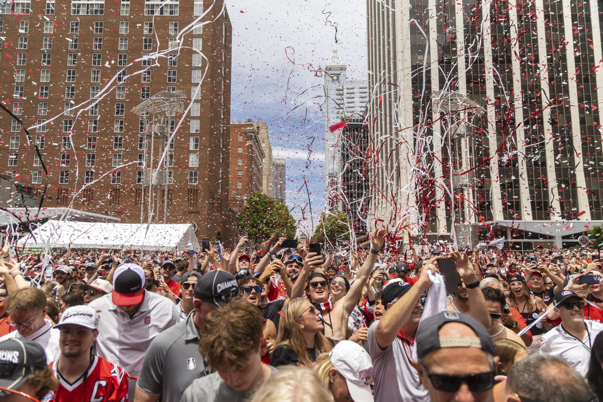 Red and white confetti falls over thousands of fans gathered along the streets during the Championship Celebration in downtown Raleigh on Saturday, June 20, 2026. Local officials estimated that the parade drew one of the largest crowds in the city's sports history.