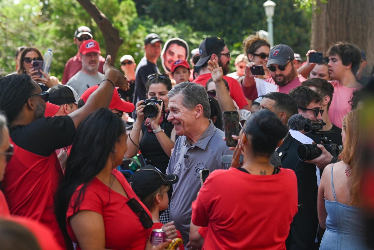 Former NC Governor Roy Cooper speaks with fans during the Carolina Hurricanes Championship Parade in Downtown Raleigh on June 20, 2026. The parade celebrated the Hurricanes victory in the 2026 Stanley Cup after 20 years.