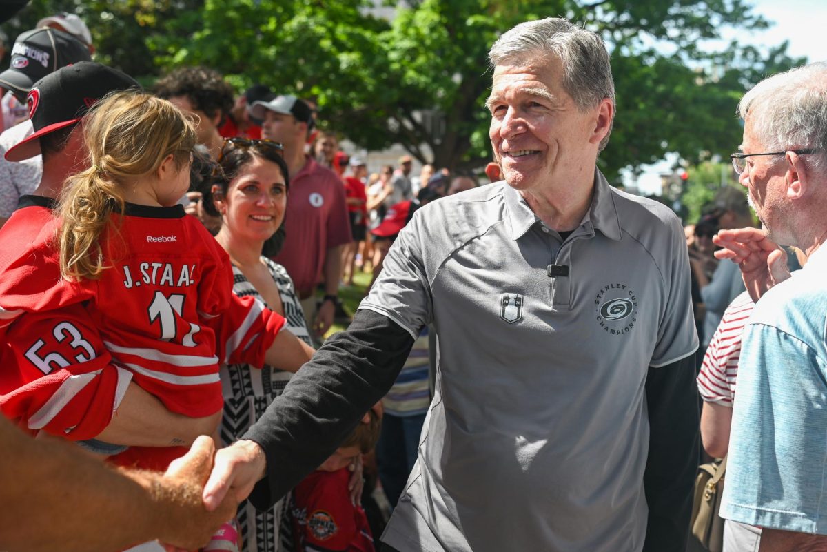 A wide shot of Fayetteville Street during the Carolina Hurricanes Championship Parade in Downtown Raleigh on June 20, 2026. The parade celebrated the Hurricanes victory in the 2026 Stanley Cup after 20 years.