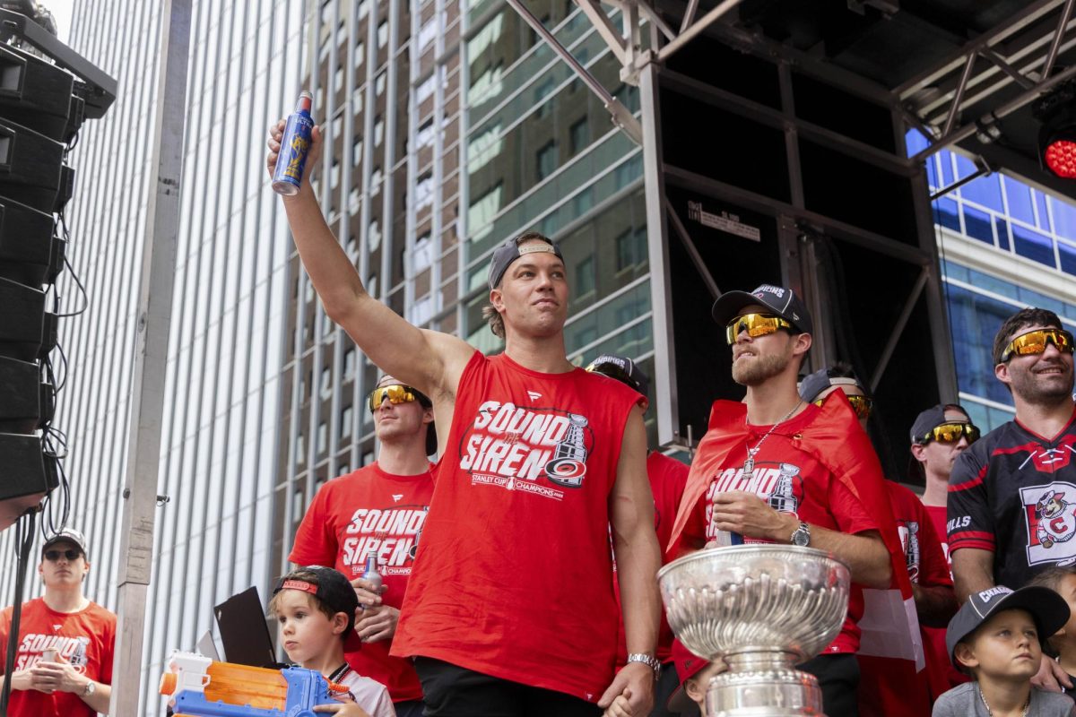 Left wing Taylor Hall raises a drink to toast the crowd during the Championship Celebration in downtown Raleigh on Saturday, June 20, 2026. Hall joined the team's veterans on the final float of the afternoon.