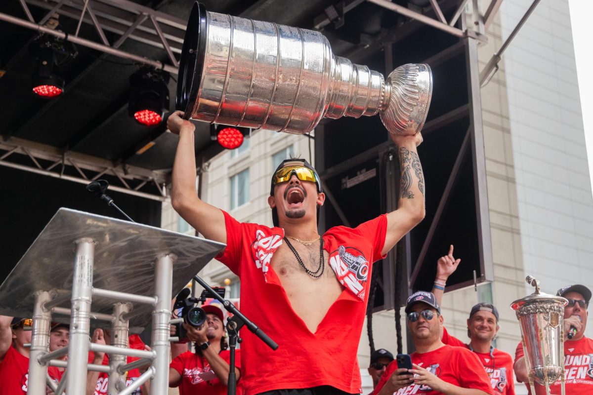 Center Seth Jarvis lifts the Stanley Cup above his head during the Championship Celebration in downtown Raleigh on Saturday, June 20, 2026. Jarvis finished the postseason as one of the team's top scoring contributors.