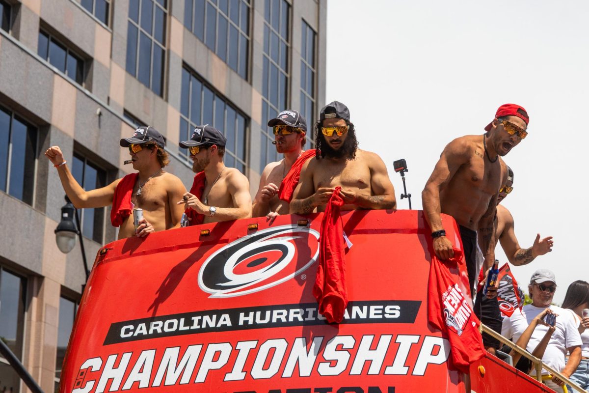 Carolina Hurricanes players celebrate on top of a double-decker parade bus during the Championship Celebration in downtown Raleigh on Saturday, June 20, 2026. The team toured the city center to share the franchise's latest title with the community.
