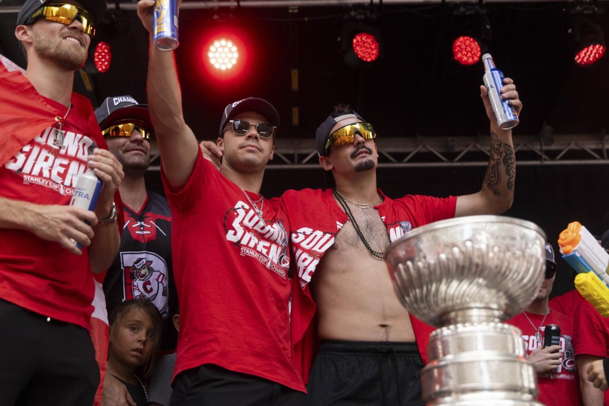 Center Logan Stankoven and center Seth Jarvis toast the crowd during the Championship Celebration in downtown Raleigh on Saturday, June 20, 2026. The young forwards shared a moment with fans who gathered near the main stage.
