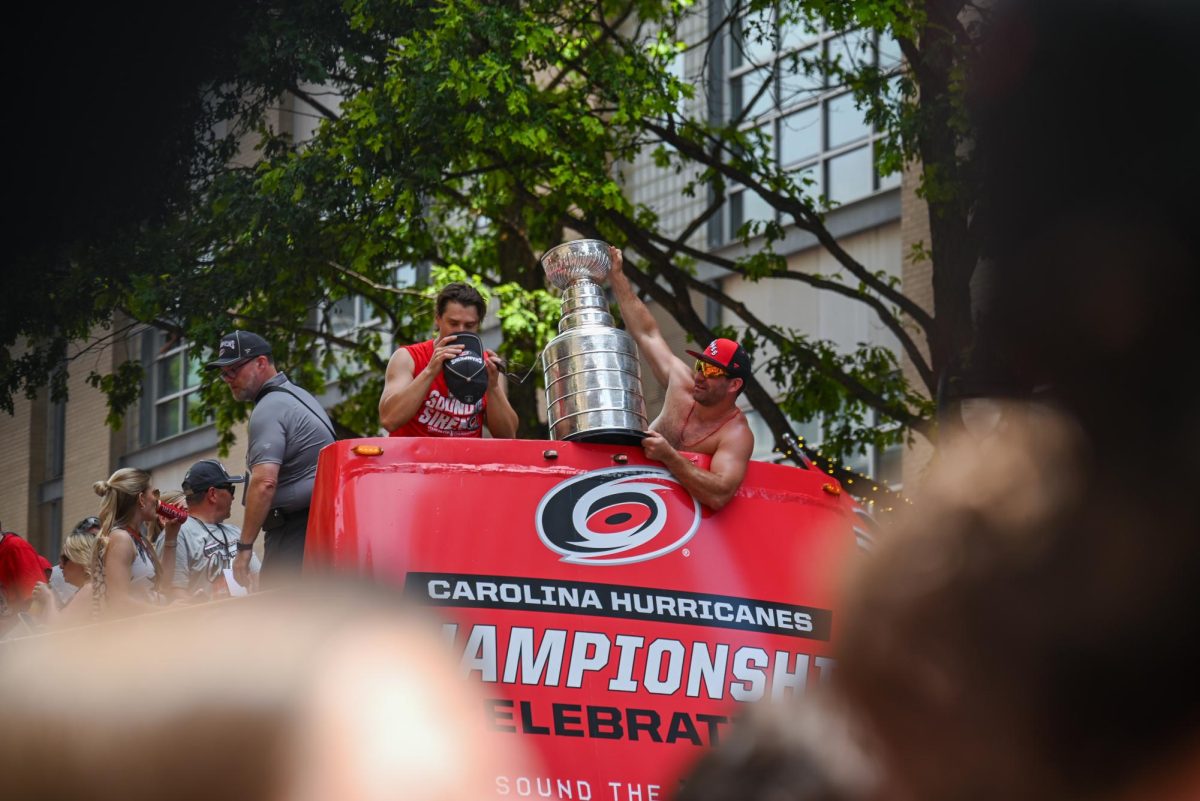 Center Sebastian Aho and left wing Jordan Martinook showcase the Stanley Cup Trophy to the fans during the Carolina Hurricanes Championship Parade in Downtown Raleigh on June 20, 2026. The parade had an attendance of 100000+ hockey fans from all parts of NC and the United States.