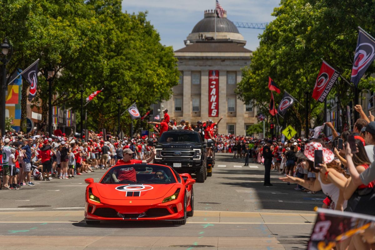 Carolina Hurricanes General Manager Don Waddell rides in a red Ferrari along the parade route during the Championship Celebration in downtown Raleigh on Saturday, June 20, 2026. Fans lined the streets early in the morning to catch a glimpse of the front office staff and players.