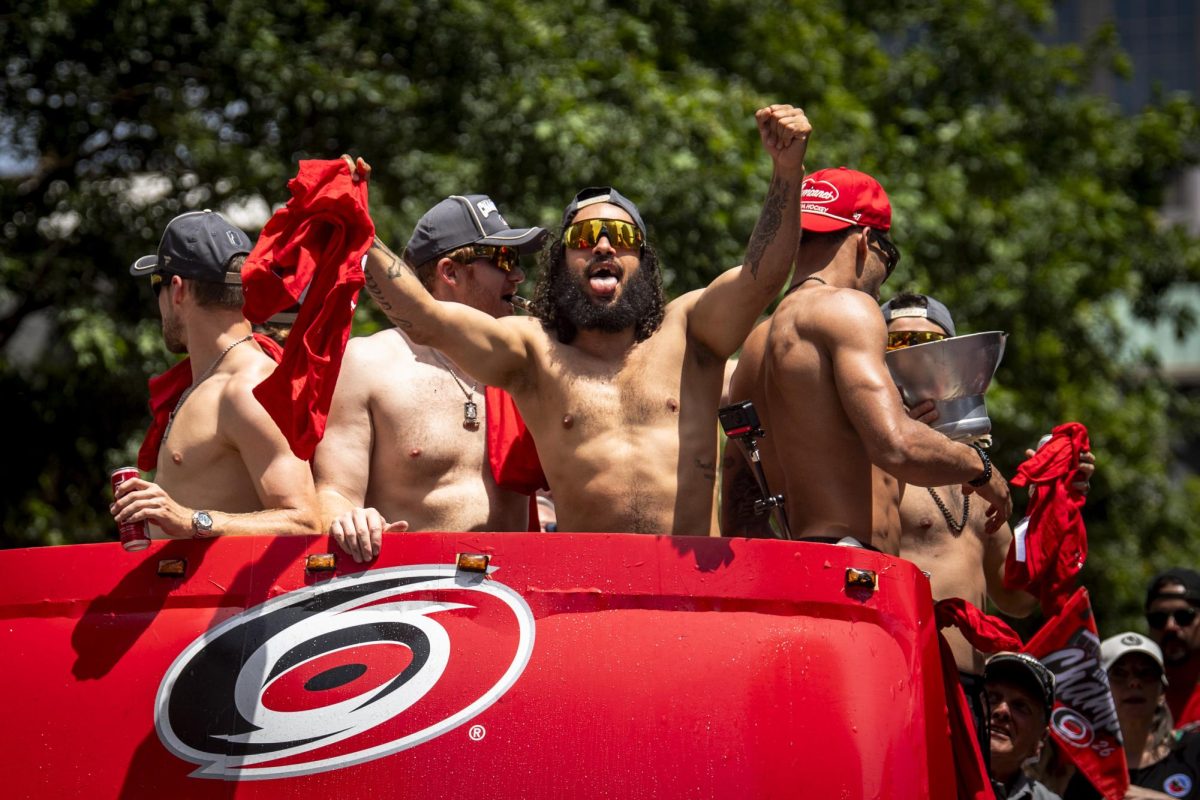 Defenseman Jalen Chatfield sticks out his tongue during the Carolina Hurricanes Championship Celebration in downtown Raleigh on Saturday, June 20, 2026.