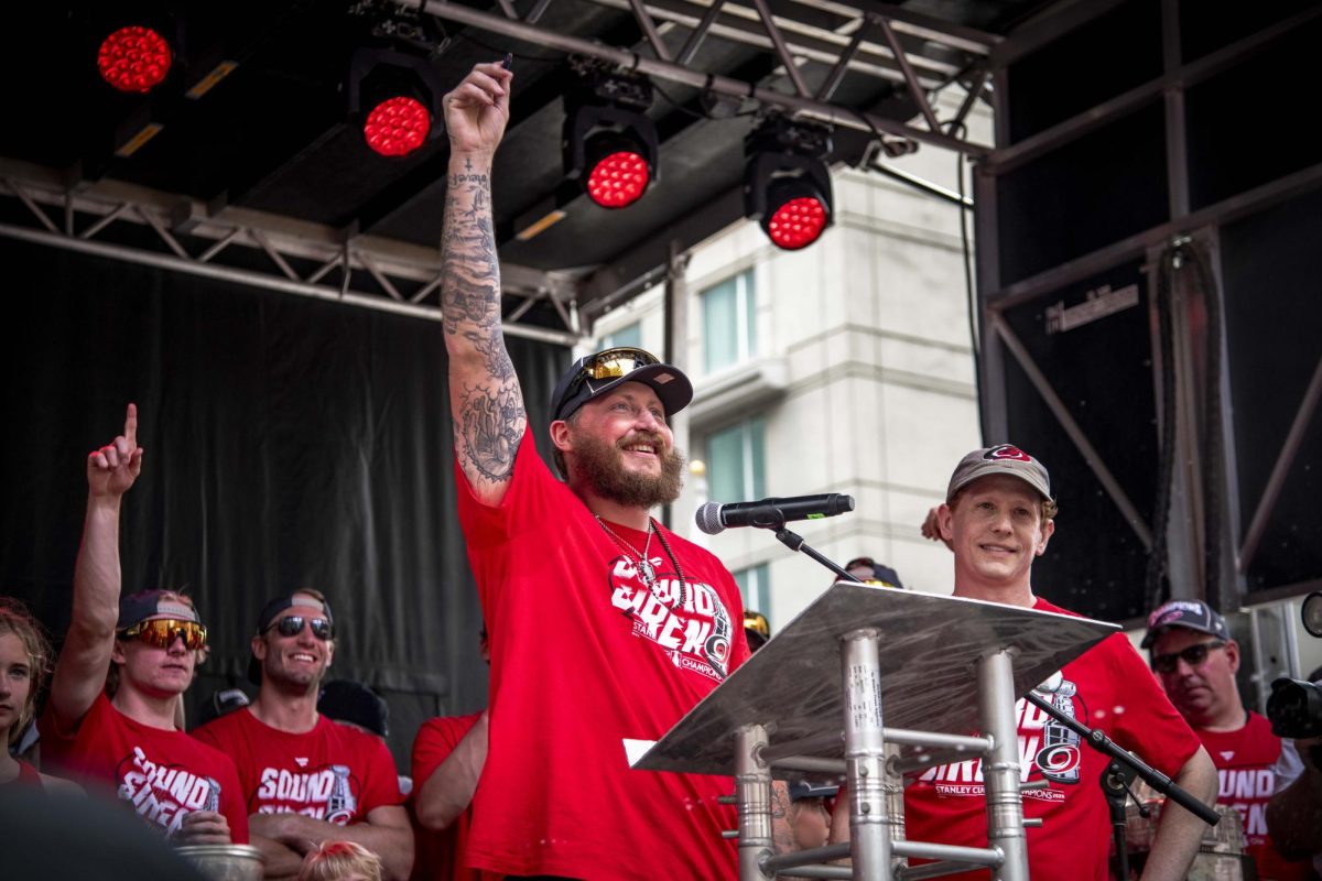Winger Nicolas Deslauriers smiles on stage during the Carolina Hurricanes Championship Celebration in downtown Raleigh on Saturday, June 20, 2026. Deslauriers celebrated signing a new two-year contract as well as the Stanley Cup victory during the celebration.