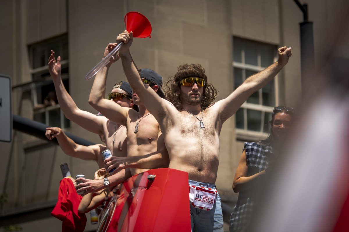Defenseman Shayne Gostisbehere motions to the crowd with his funnel and wig during the Carolina Hurricanes Championship Celebration in downtown Raleigh on Saturday, June 20, 2026.