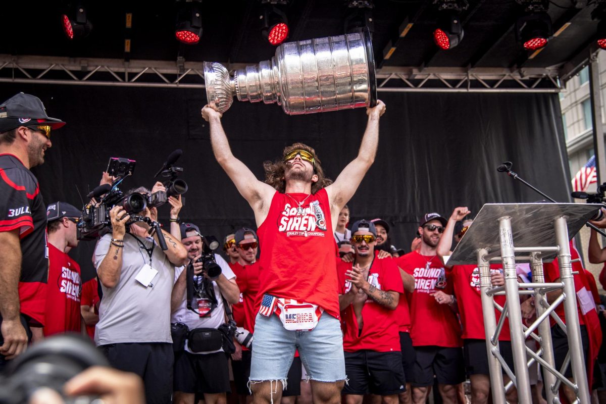 Defenseman Shayne Gostisbehere holds up the Stanley Cup during the Carolina Hurricanes Championship Celebration in downtown Raleigh on Saturday, June 20, 2026.