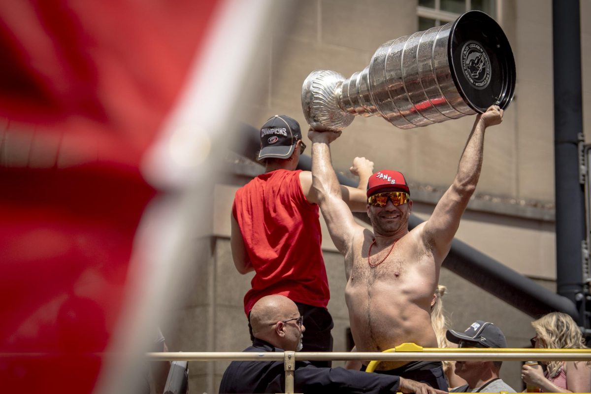 Winger Jordan Martinook holds up the Stanley Cup during the Carolina Hurricanes Championship Celebration in downtown Raleigh on Saturday, June 20, 2026.