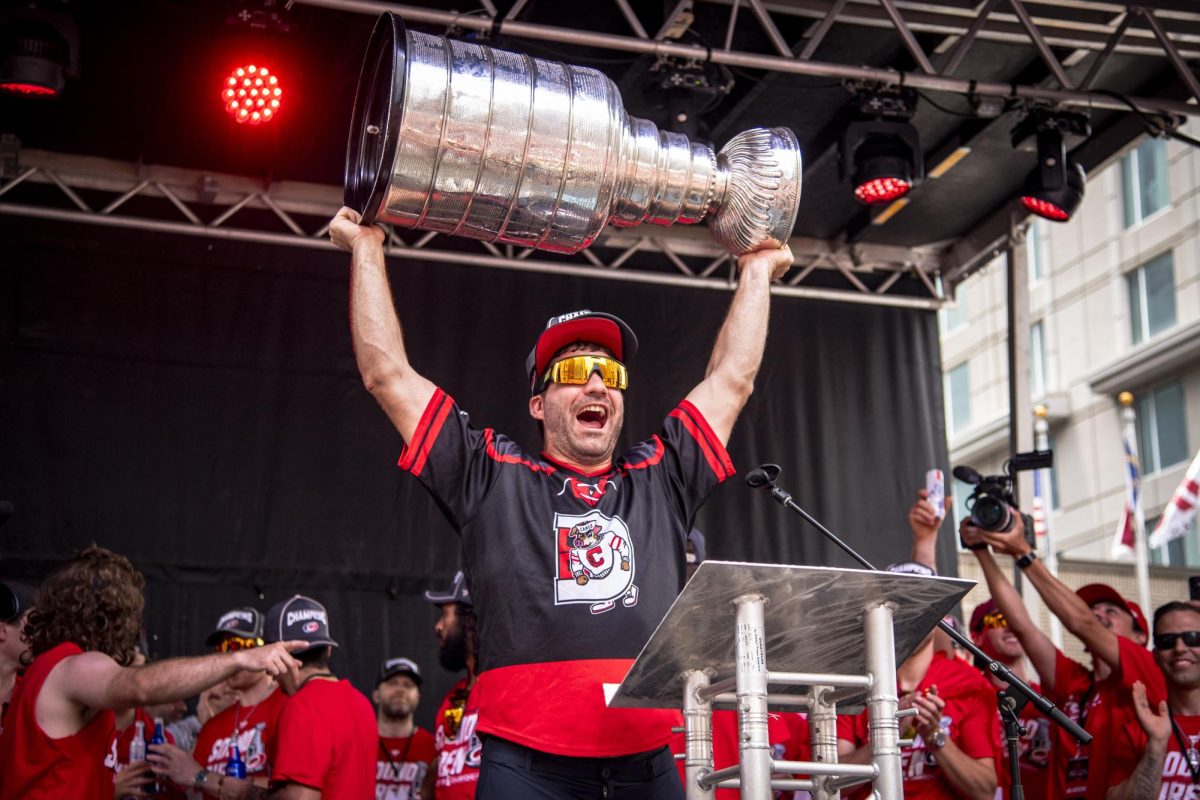 Winger Jordan Martinook holds up the Stanley Cup during the Carolina Hurricanes Championship Celebration in downtown Raleigh on Saturday, June 20, 2026.