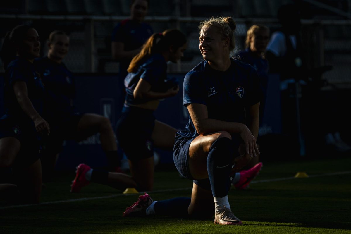 Forward Hannah Betfort (33) smiles while stretching before the game against Seattle Reign FC in First Horizon Stadium at WakeMed Soccer Park on Saturday, July 4, 2026. NC Courage FC defeated Seattle Reign FC 3-1.