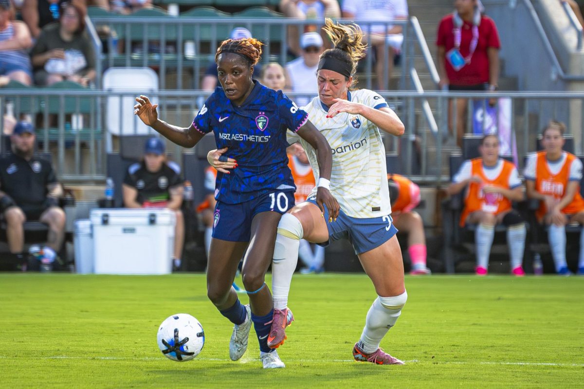 Forward Evelyn Ijeh (10) fights for possession of the ball during the game against Seattle Reign FC in First Horizon Stadium at WakeMed Soccer Park on Saturday, July 4, 2026. NC Courage FC defeated Seattle Reign FC 3-1.