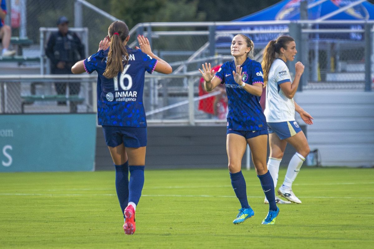 Midfielders Riley Jackson (16) and Ashley Sanchez (2) high-five after Sanchez's first goal of the game against Seattle Reign FC in First Horizon Stadium at WakeMed Soccer Park on Saturday, July 4, 2026. NC Courage FC defeated Seattle Reign FC 3-1.