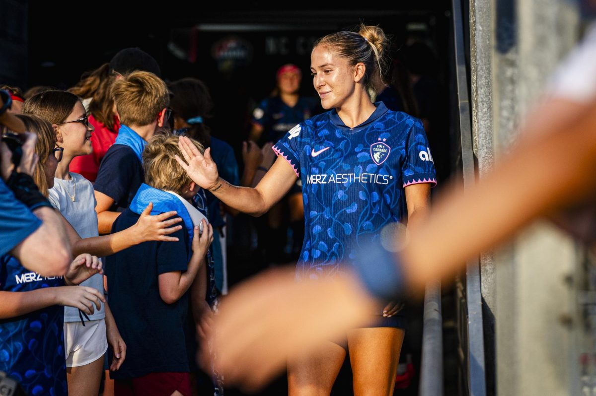 Midfielder Ashley Sanchez (2) high-fives young fans before the game against Seattle Reign FC in First Horizon Stadium at WakeMed Soccer Park on Saturday, July 4, 2026. NC Courage FC defeated Seattle Reign FC 3-1.