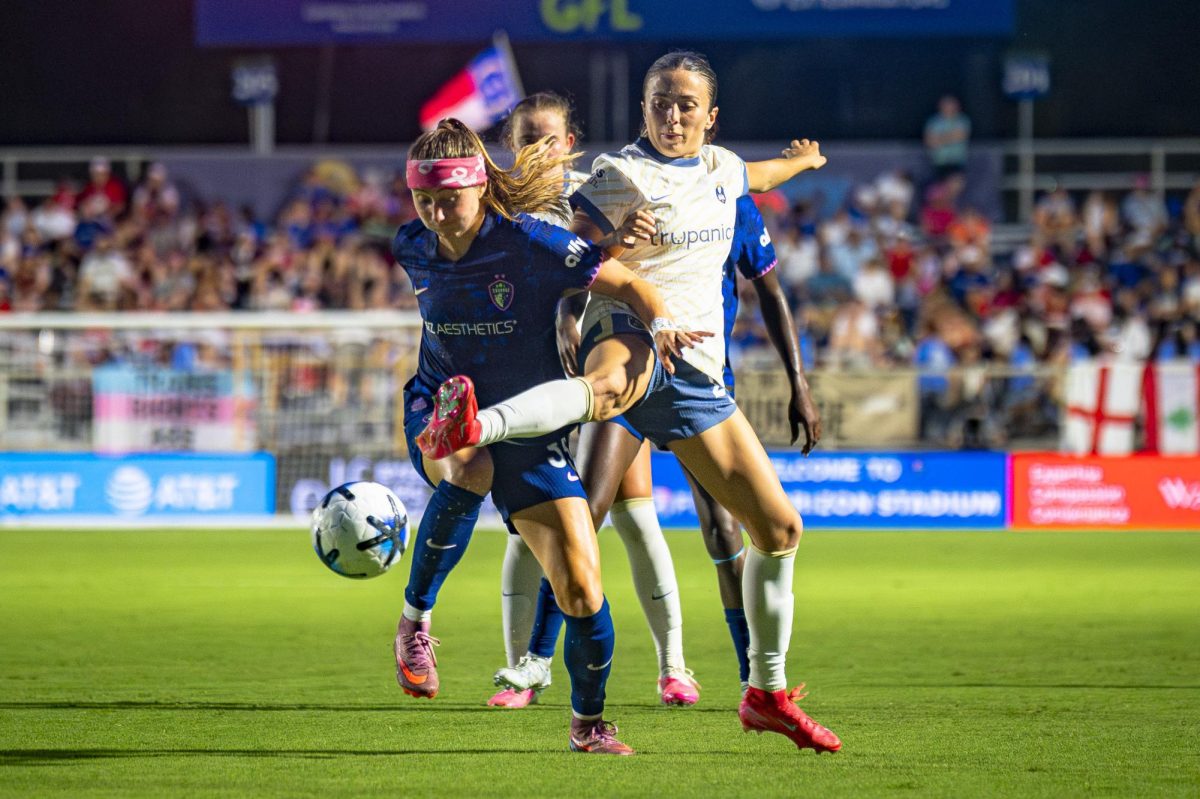 Forward Ally Schlegel (35) battles with Seattle Reign FC defender Madison Curry (24) during the game in First Horizon Stadium at WakeMed Soccer Park on Saturday, July 4, 2026. NC Courage FC defeated Seattle Reign FC 3-1.