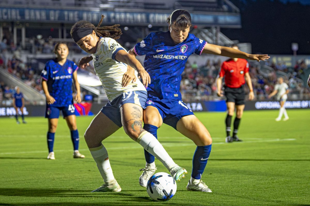 Defender Uno Shiragaki (18) jostles for possession with forward Mia Fishel (19) during the game against Seattle Reign FC in First Horizon Stadium at WakeMed Soccer Park on Saturday, July 4, 2026. NC Courage FC defeated Seattle Reign FC 3-1.