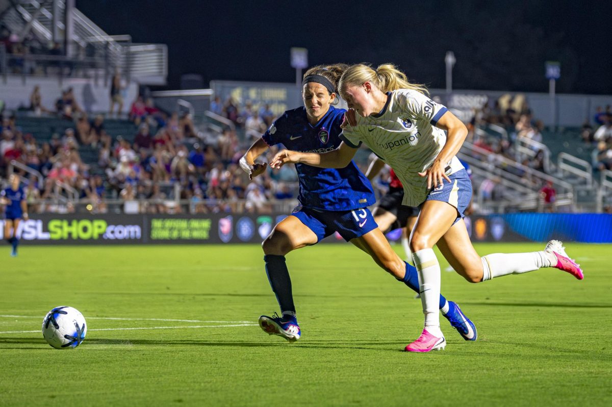 Defender Ryan Williams (13) speeds to the ball against Seattle Reign FC forward Maddie Dahlien (5) during the game in First Horizon Stadium at WakeMed Soccer Park on Saturday, July 4, 2026. NC Courage FC defeated Seattle Reign FC 3-1.